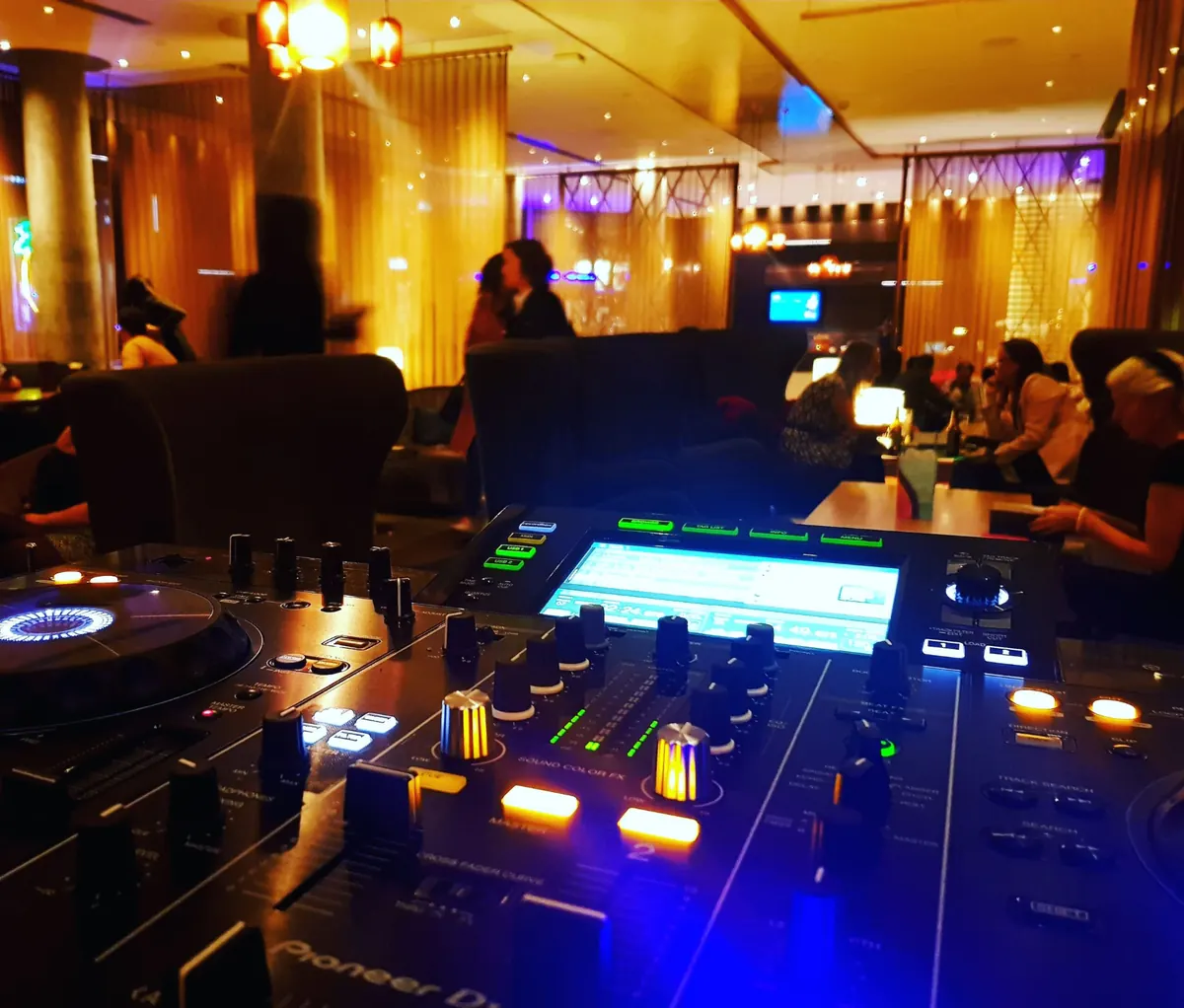 Corporate event DJ setup with dance floor lighting