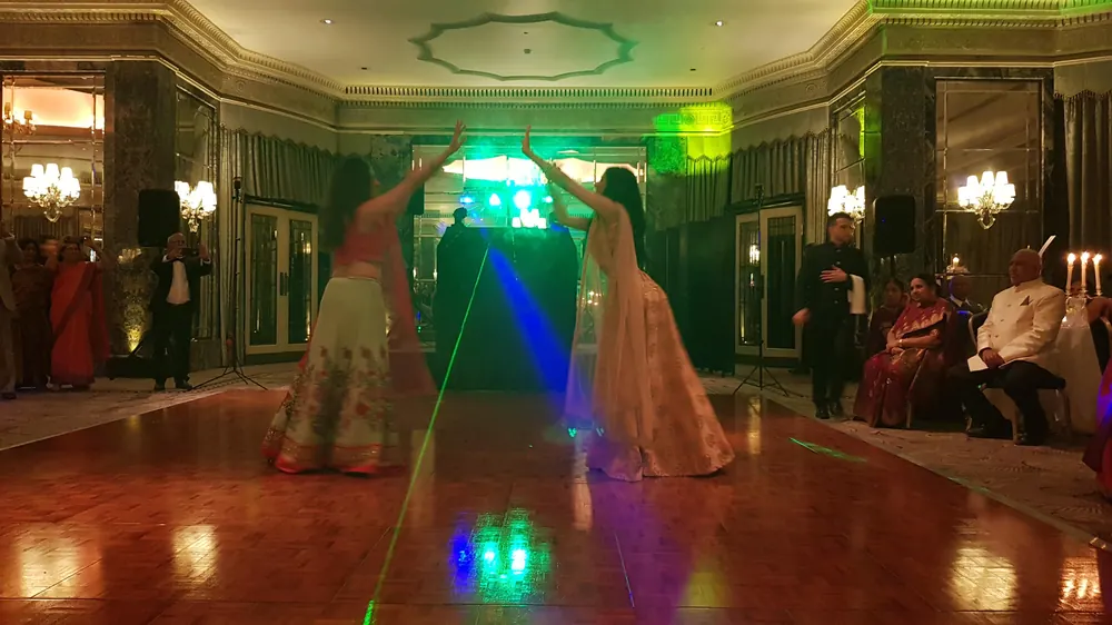 Two dancers performing for the guests on a grand ballroom dance floor