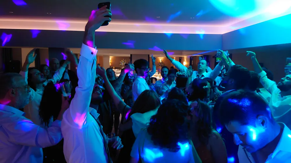 A packed dance floor under blue lighting