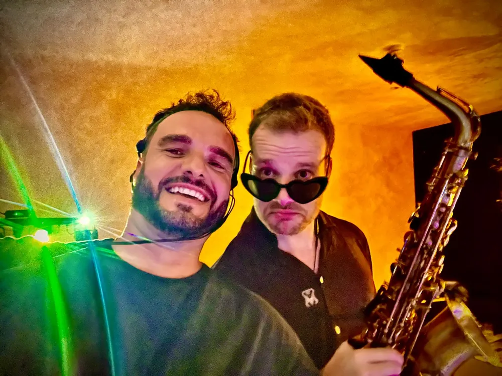 DJ and saxophonist together behind the decks